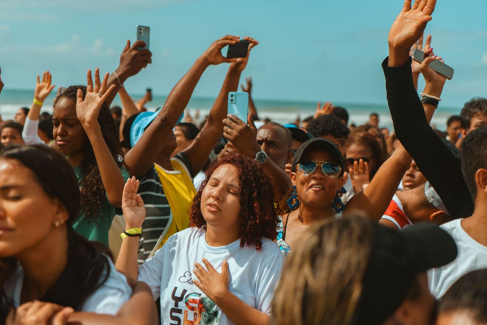 Crowd with hands in the air at a beach event